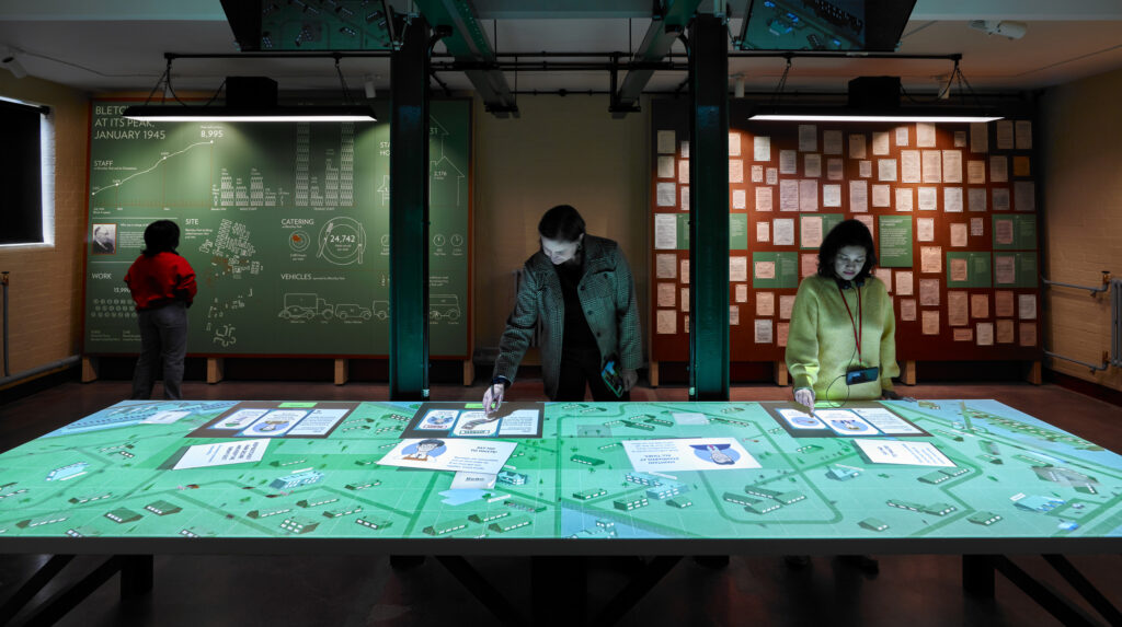 Lighting design enhances The Intelligence Factory, seamlessly illuminating artefacts and narratives for an immersive exhibition.