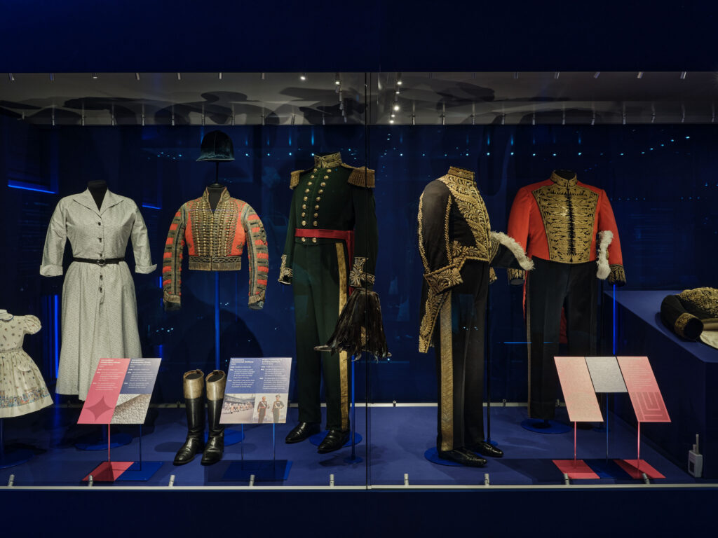 Exhibition lighting design by Michael Grubb Studio, award-winning lighting consultants, highlighting historical garments in Dress Codes exhibition at Kensington Palace in London, United Kingdom