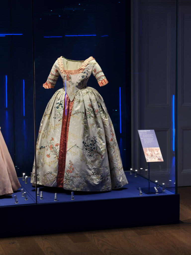 Textile conservation lighting by Michael Grubb Studio showcasing fashion and identity in a heritage exhibition "Dress Codes" at Kensington Palace