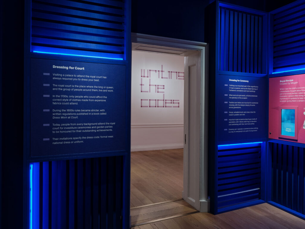 Museum lighting design by Michael Grubb Studio, award-winning lighting consultants, highlighting historical garments in Dress Codes exhibition at Kensington Palace