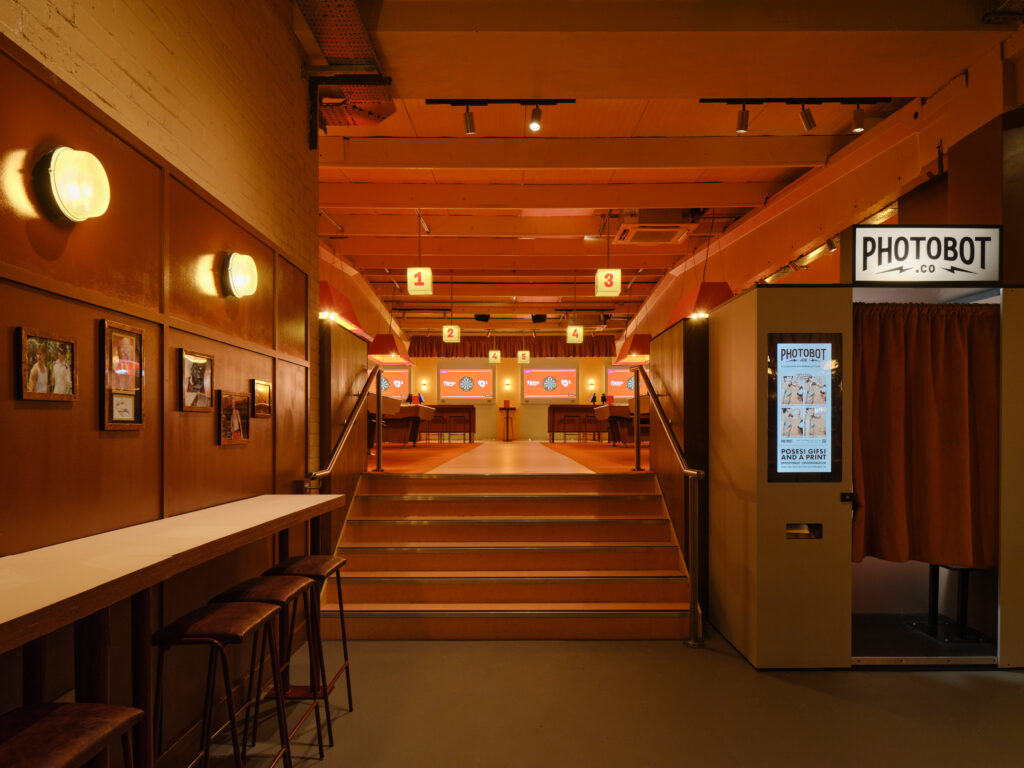 Moody warm hospitality lighting scheme from award-winning lighting design consultants Michael Grubb Studio in social games venue, London